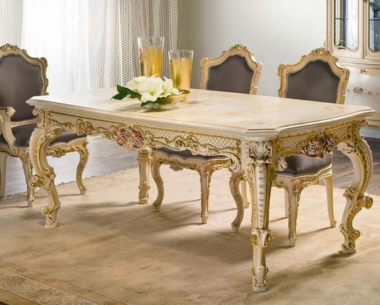 Elegant dining room with a ornate table and chairs, featuring a chandelier.