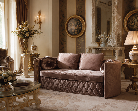 A luxurious upholstered sofa in a rich taupe-brown velvet fabric, styled in an ornate, classic European living room with gold accents, a fireplace, and decorative tables.