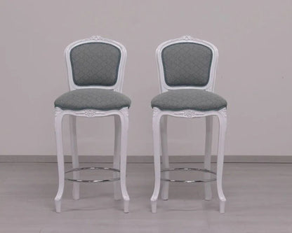 Two white bar stools with gray seats on a plain background