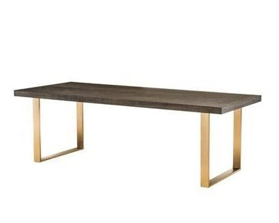 Rectangular table with wooden top and gold metal legs on a white background
