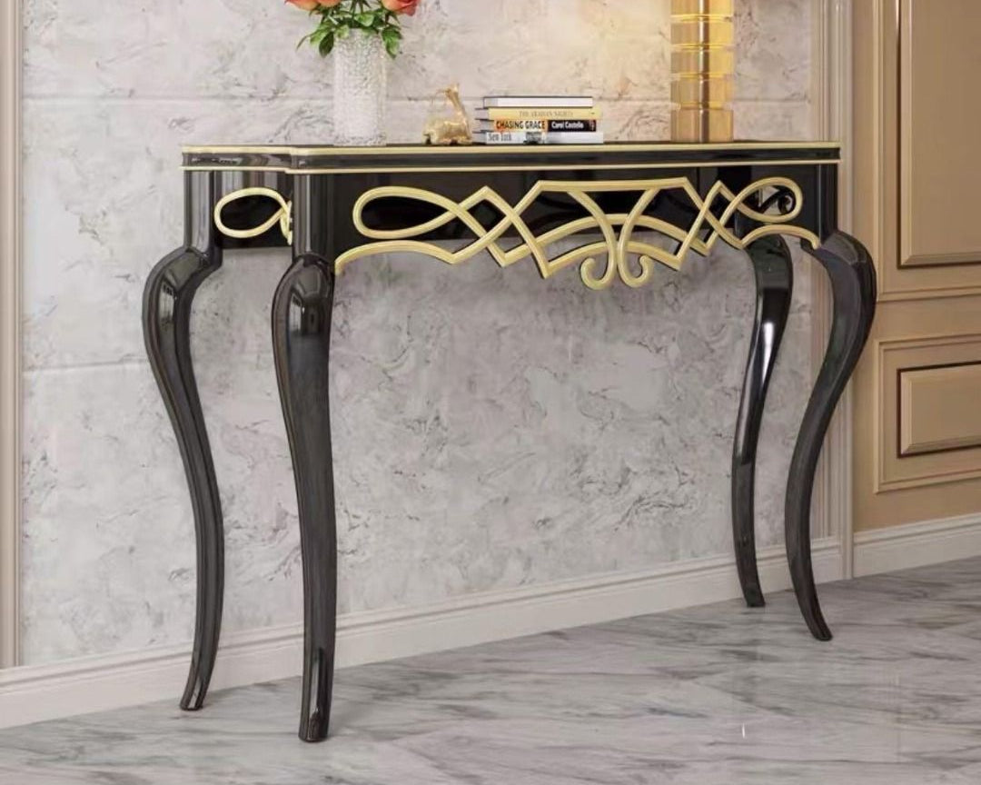 Decorative console table with gold accents in a stylish room setting, featuring 'Dainte Living' branding.