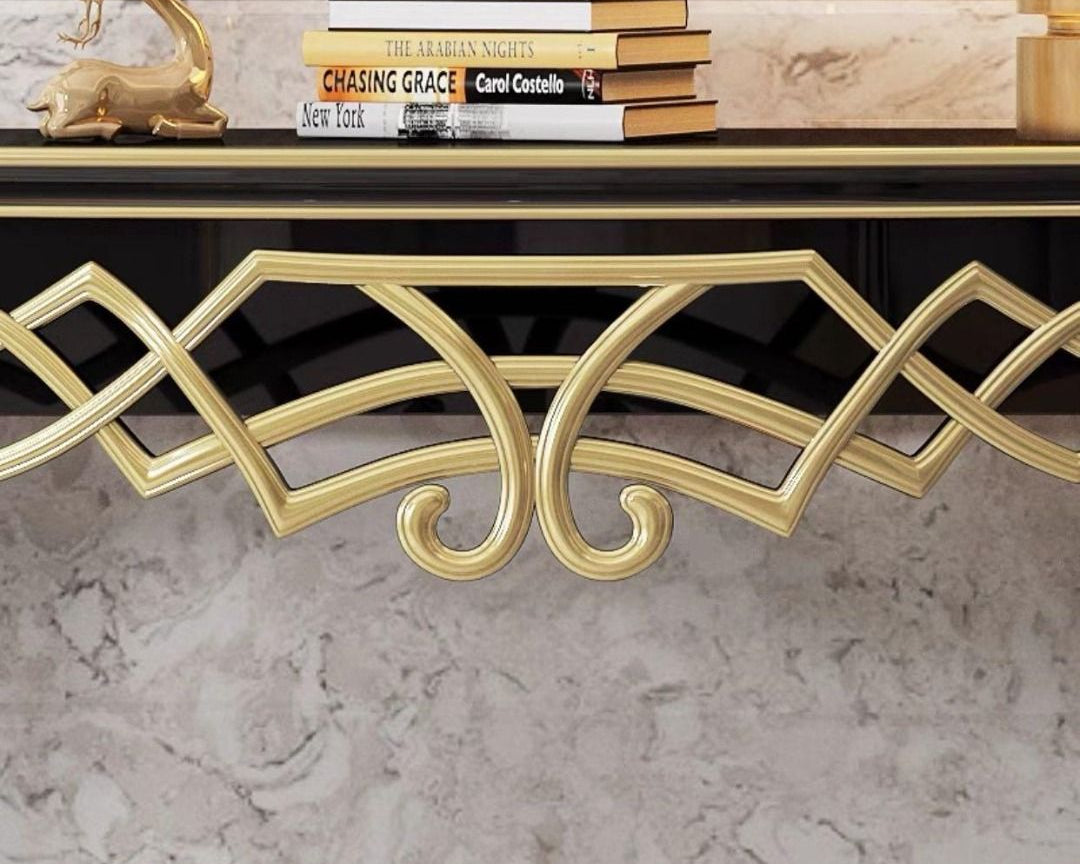 Gold console table with decorative elements on a marble surface, featuring the brand 'Dainte Living'.