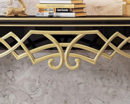 Gold console table with decorative elements on a marble surface, featuring the brand 'Dainte Living'.