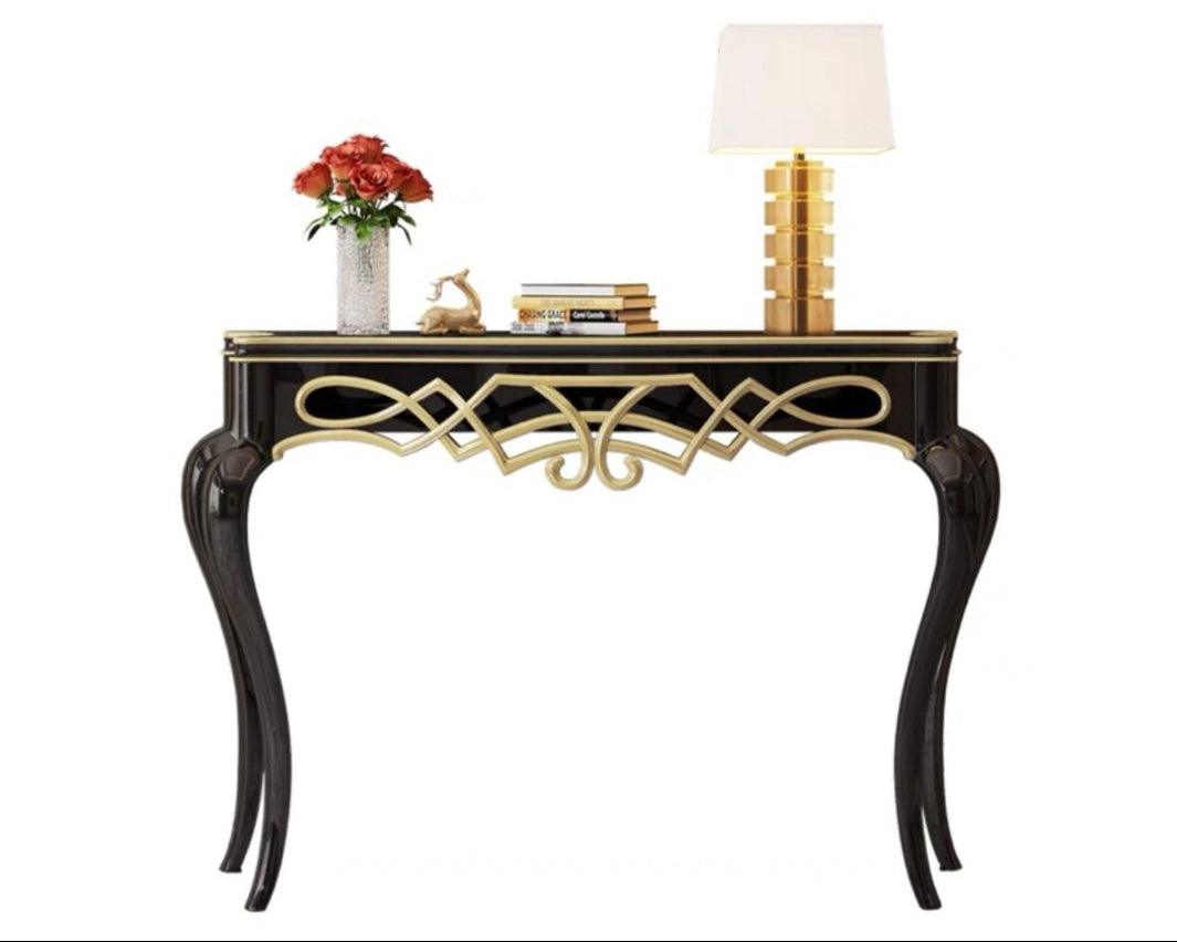 Decorative console table with gold accents and a lamp, featuring the Dainte Living brand.