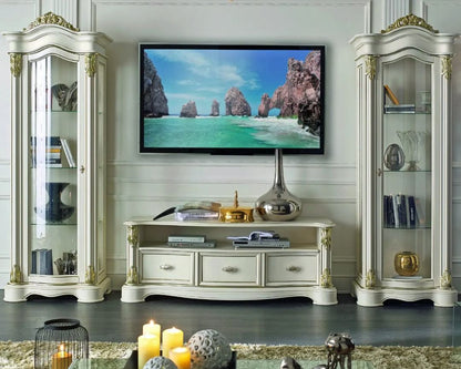 Living room with a television displaying a scenic view, flanked by two ornate display cabinets.