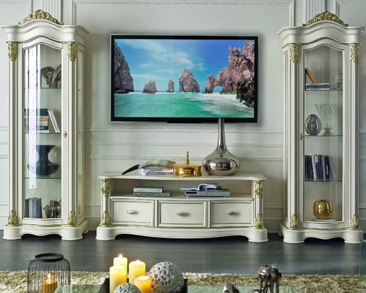 Living room with a television displaying a scenic view, flanked by two ornate display cabinets.