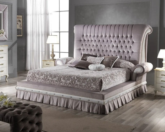 Luxurious bedroom with a tufted bed and matching headboard.
