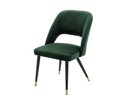 Green velvet chair with black legs on a white background