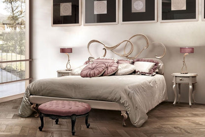 Neatly made bed with decorative pillows in a bedroom setting.