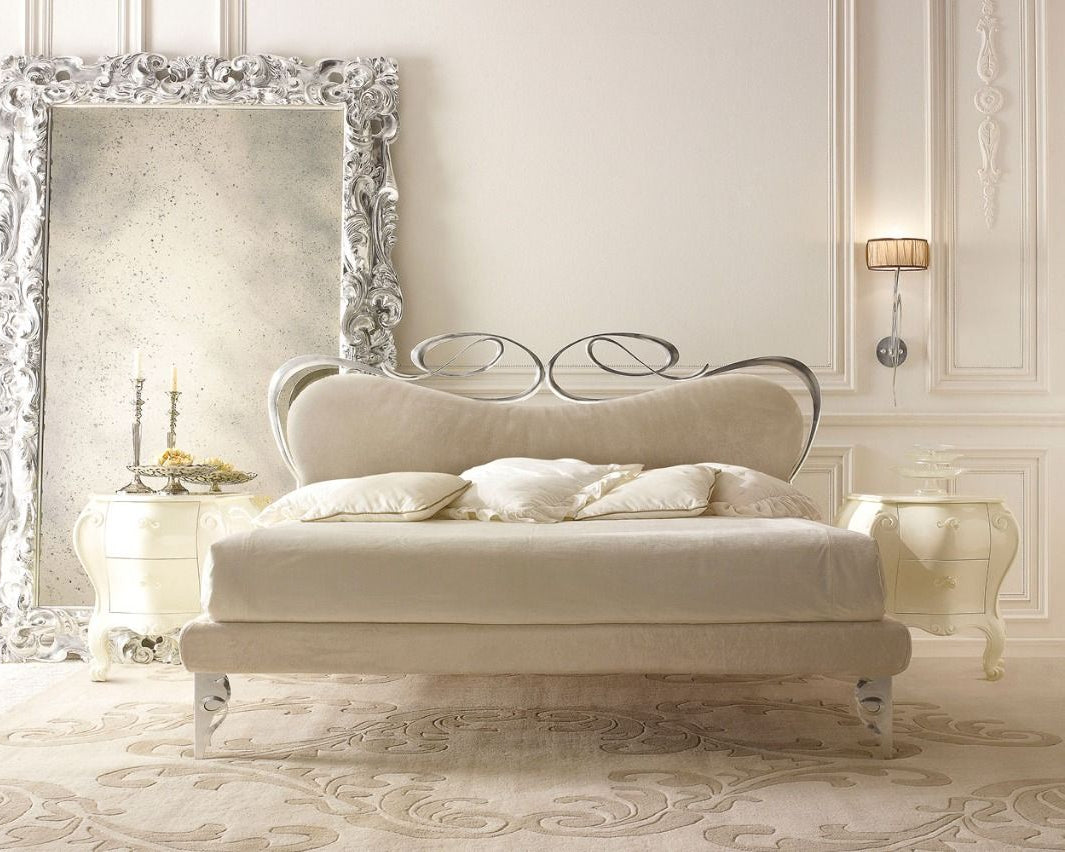 Luxurious bed with decorative headboard in an elegant bedroom setting