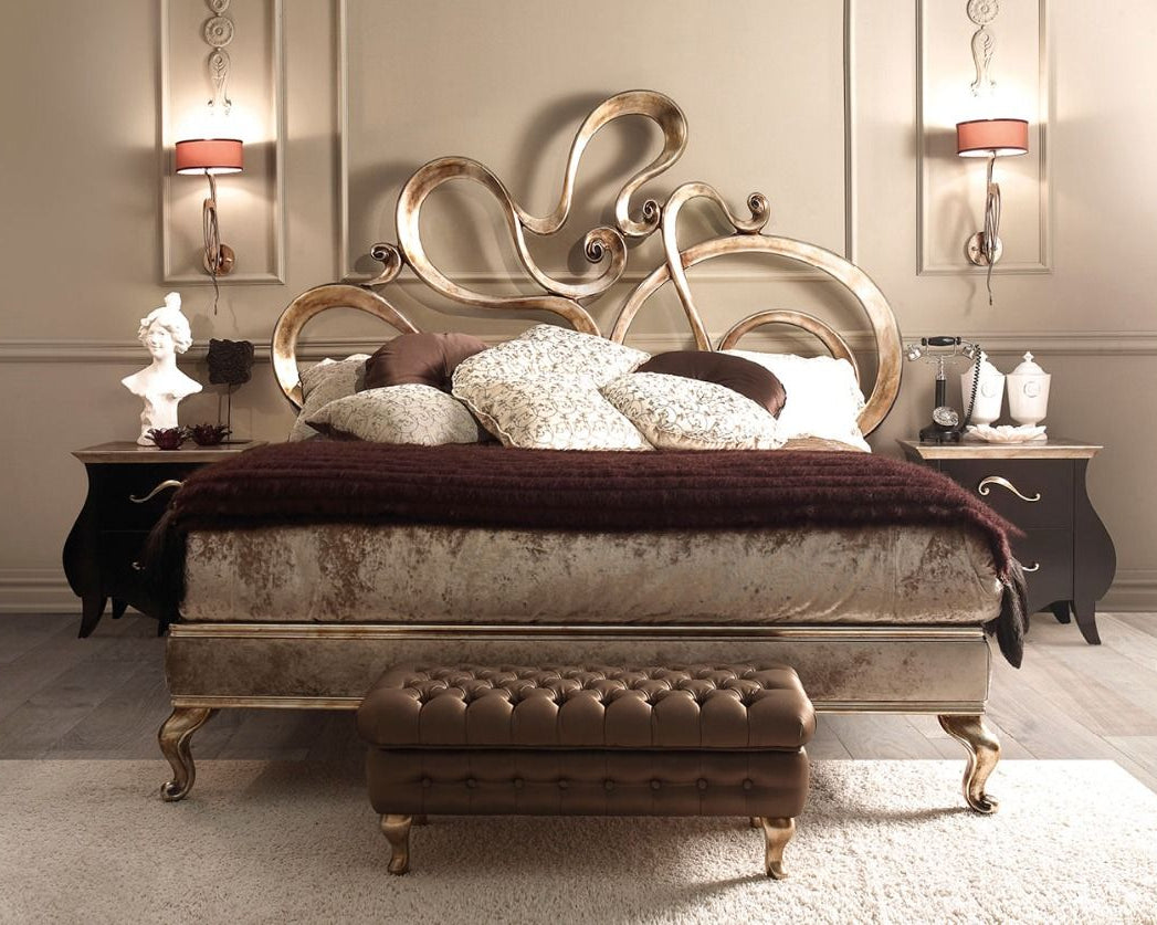 Luxurious bedroom with an ornate bed and matching footstool.