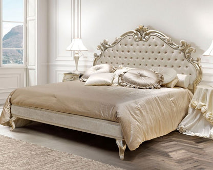 Luxurious bedroom with an ornate bed and matching headboard.