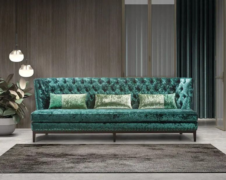 Emerald Teal cashmere crushed velvet sofa with decorative pillows in a modern living room setting.