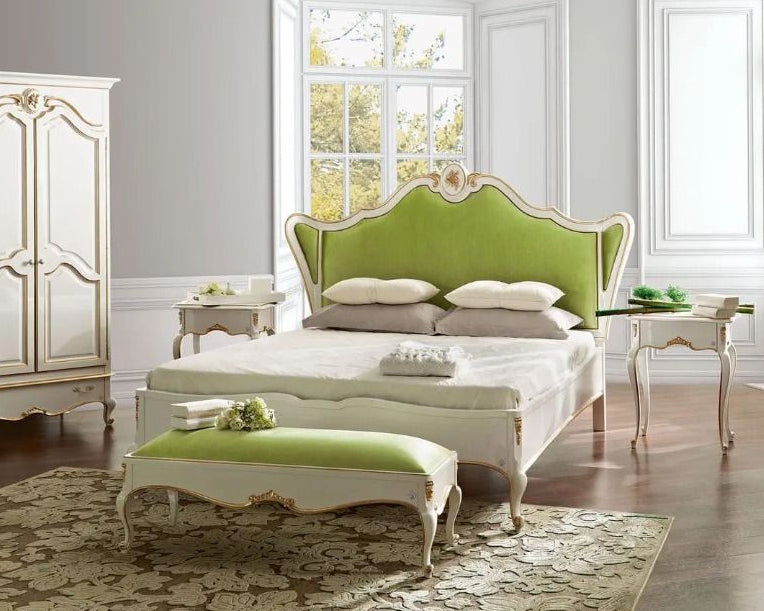 Luxurious bedroom with a green and white bed and matching ottoman.