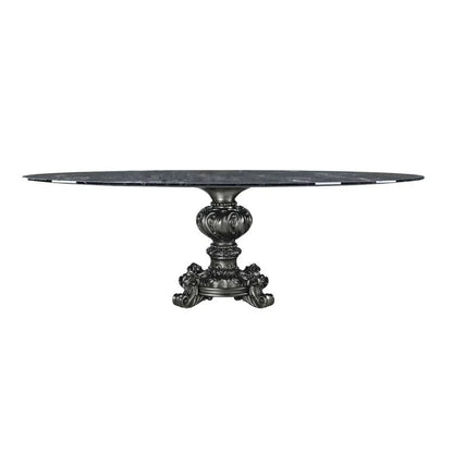Round marble table with decorative pedestal base on a white background