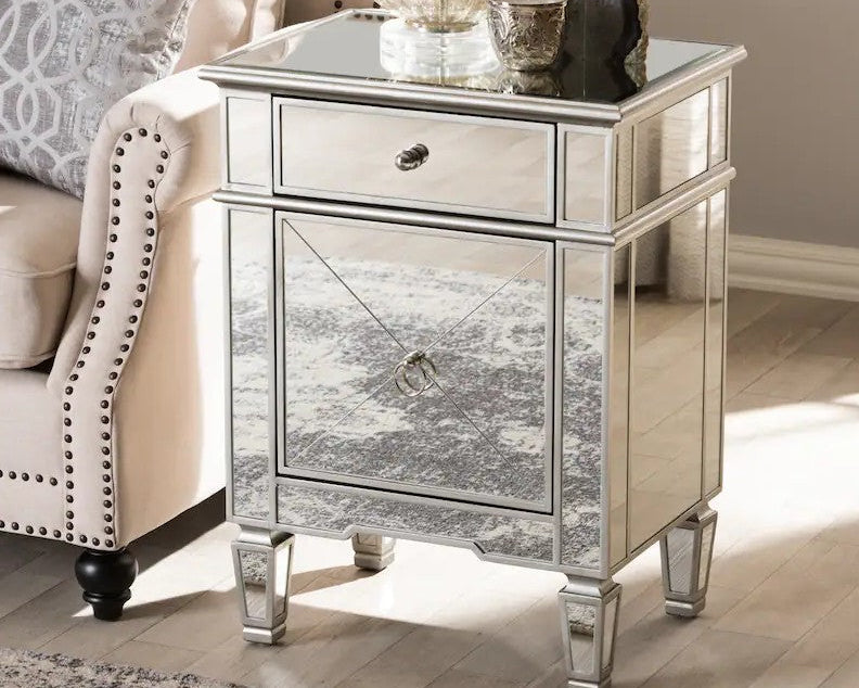 Silver mirrored nightstand with decorative items in a living room setting