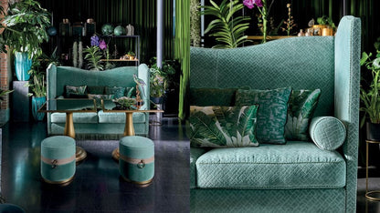 Teal sofa with decorative pillows in a stylish room with plants