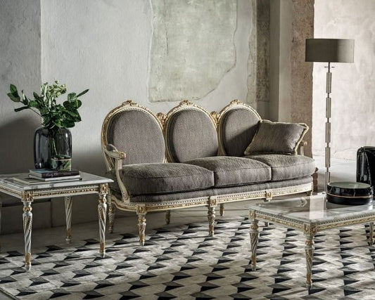 Elegant living room with Louis XVI sofa gray sofa, decorative chairs, and a patterned rug.