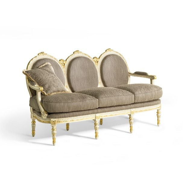 Decorative Louis XVI sofa with gold frame and beige cushions on a white background