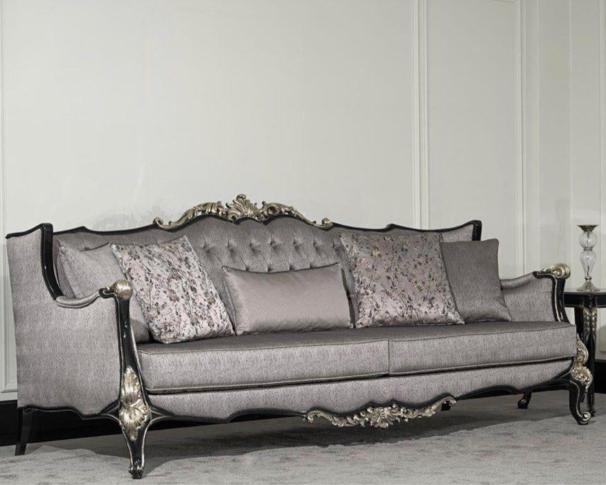 A luxurious baroque sofa with intricate carved details and a sleek lacquer finish, upholstered in gray fabric with ornate wooden frame.