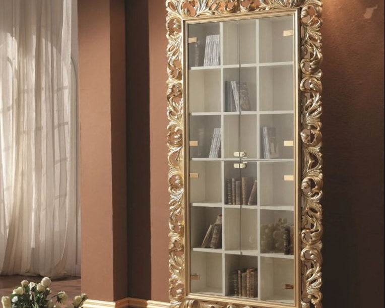 Decorative bookshelf with ornate gold frame in a room setting