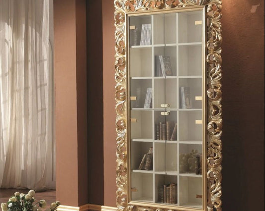 Decorative bookshelf with ornate gold frame in a room setting