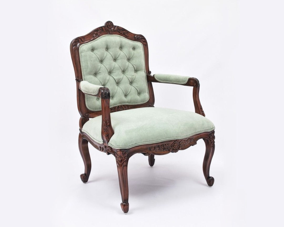 Vintage chair with green cushioned seat and backrest on a white background