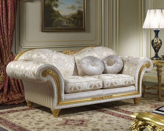 Luxurious sofa with gold accents in a classical room setting.