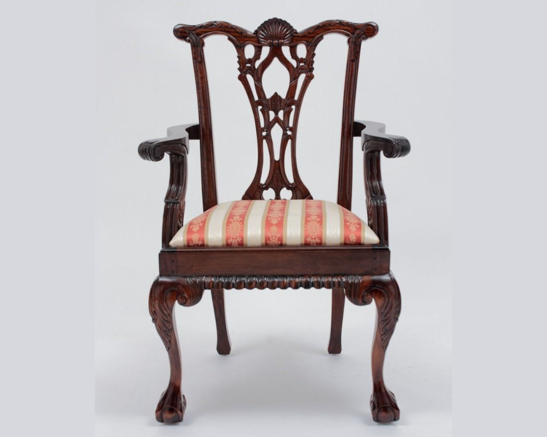 Decorative wooden chair with striped cushion on a white background