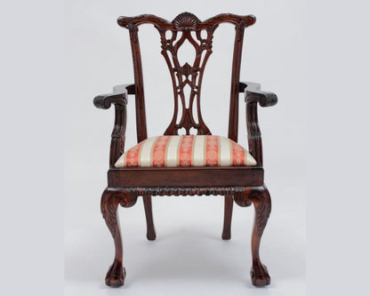 Decorative wooden chair with striped cushion on a white background