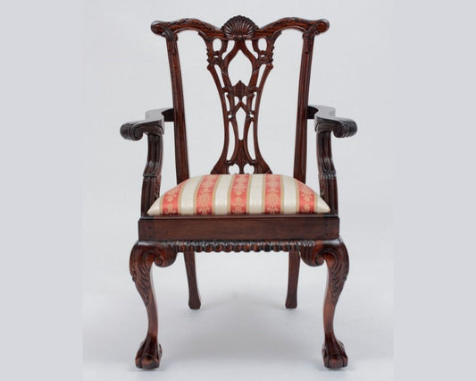 Decorative wooden chair with striped cushion on a white background