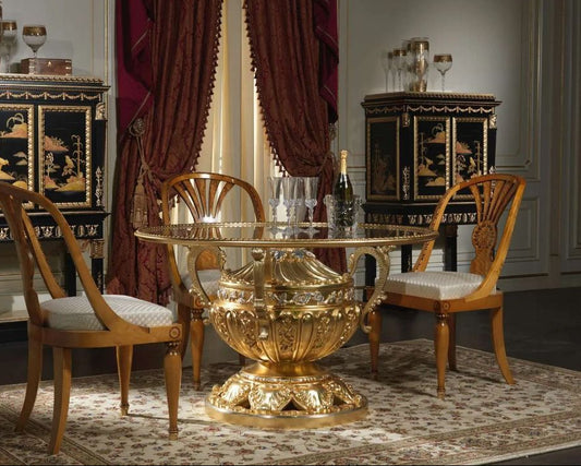 Decorative dining room with ornate gold table and chairs, black and gold sideboards, and red curtains.