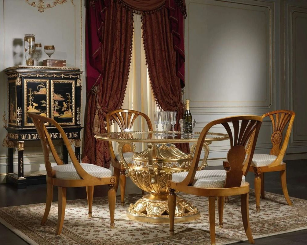 Dining room with a gold table and wooden chairs in a classic setting.