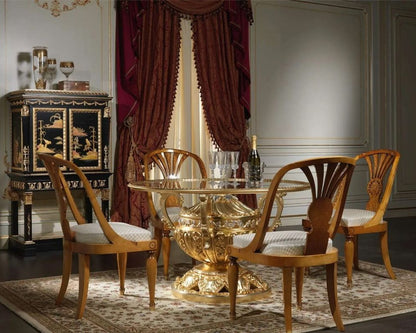 Dining room with a gold table and wooden chairs in a classic setting.